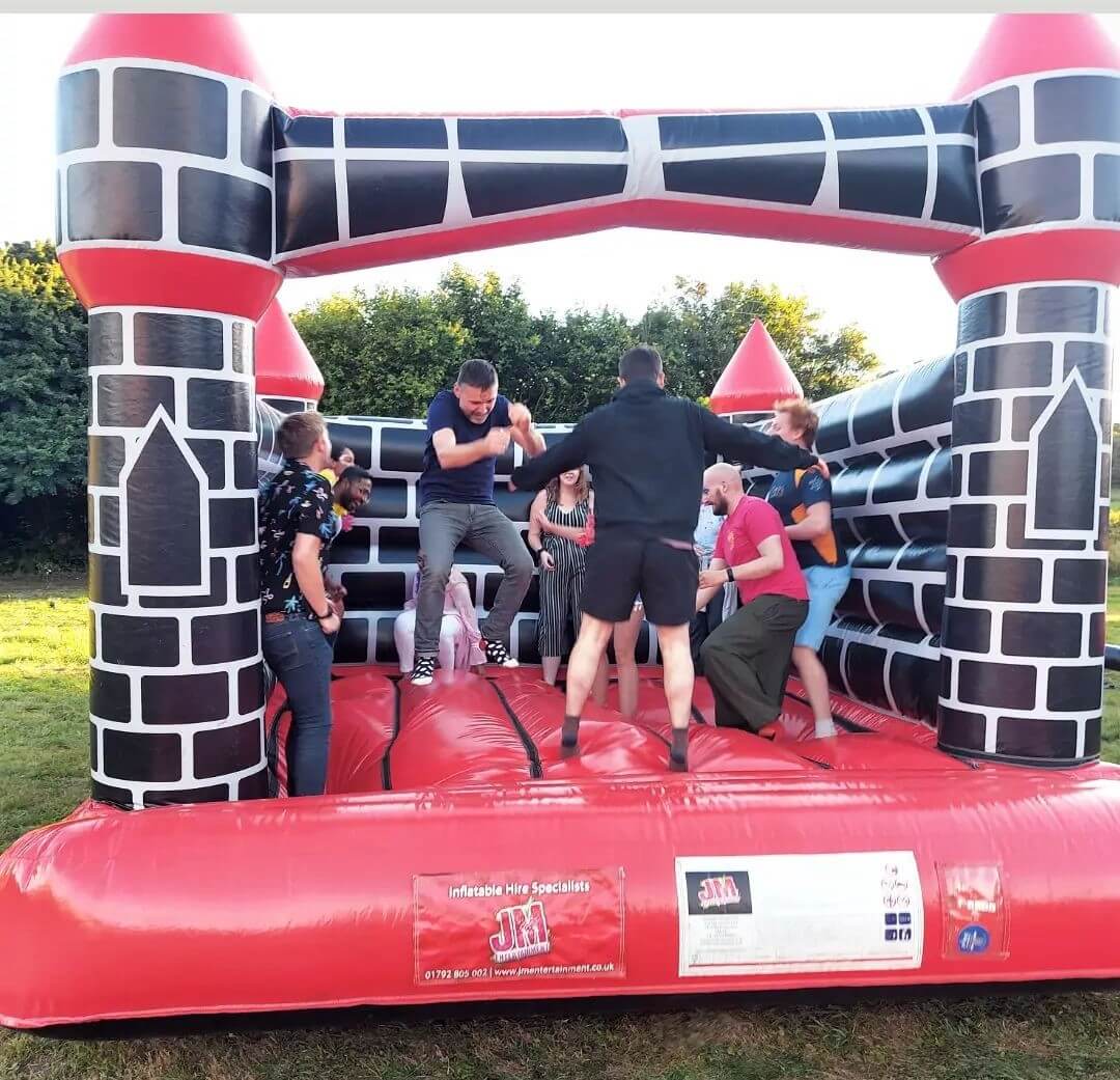 CatSci enjoy CatFest - image of team members jumping on bouncy castle