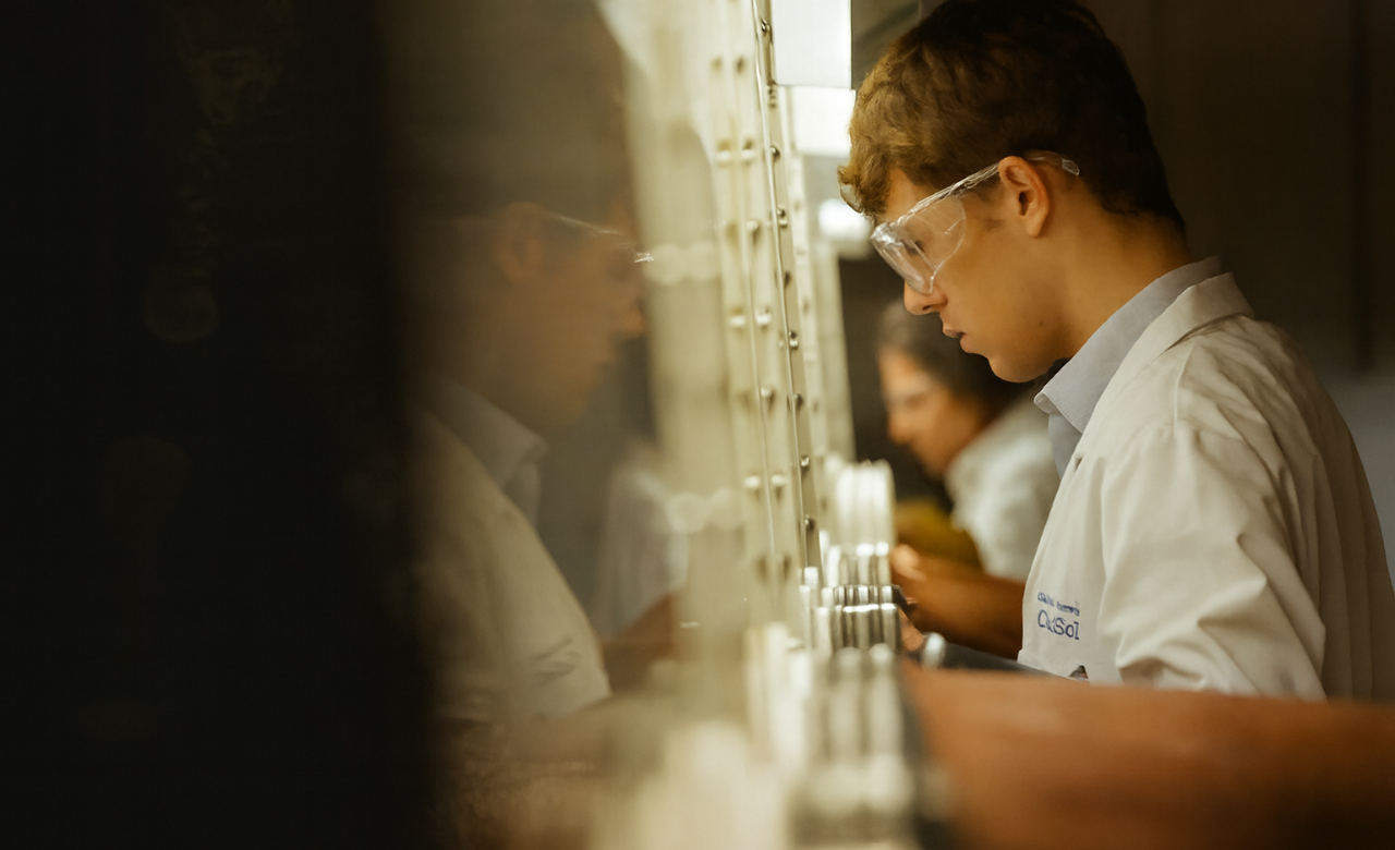 Image of male scientist in a laboratory, looking in a fumehood