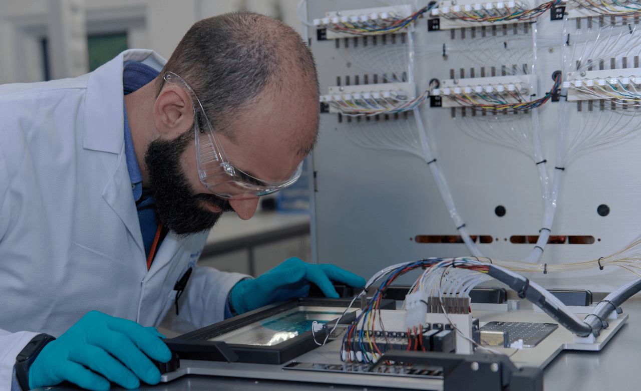 Hybrid Modality Development Services - image of male scientist working in an oligonucleotide laboratory