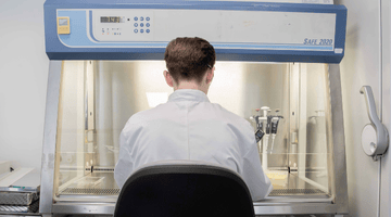 image of translational bioscience scientist working at a glovebox